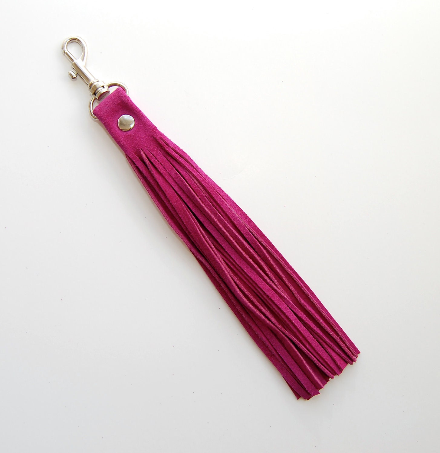 The Leather Tassel in festive fuchsia pink suede