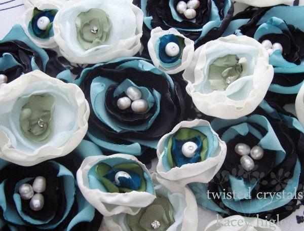 A pair of handmade innocent ivory and something blue flowers filled with a large fresh water pearl and Swarovski crystal. For your wedding, favorite shoes and life.