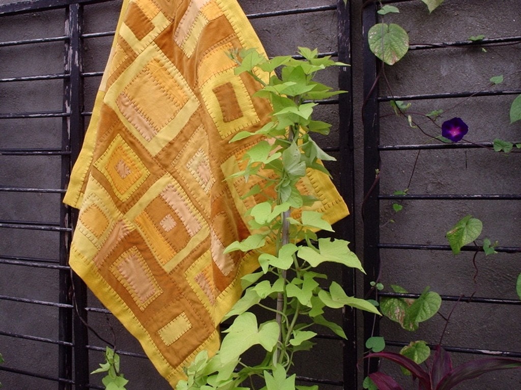 hand stitched baby quilt of assorted golden linen colors