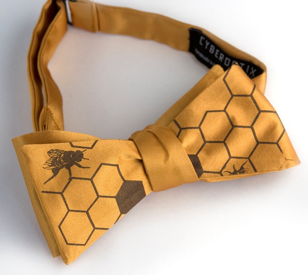 Oh Honey. Mustard yellow bow tie, self-tie. Silkscreened honeybees. Chocolate brown print.
