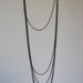 long minimal necklace with multi layered chains