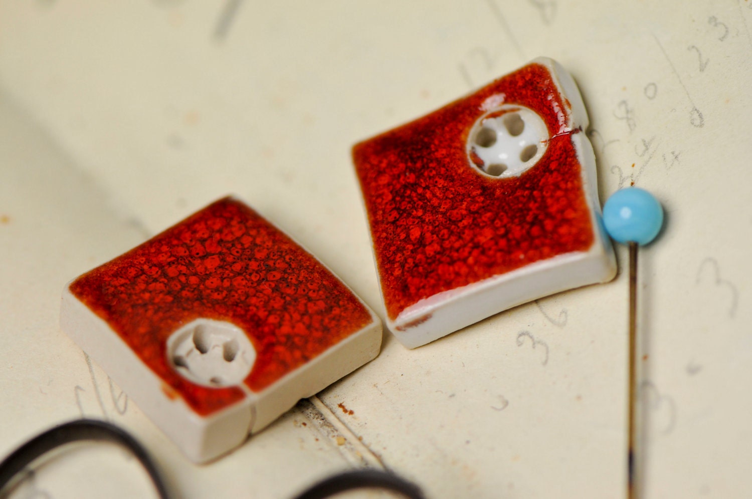 2 red square buttons....sew on buttons