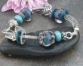 Wire Wrapped Lampwork Bracelet with Bali and Sterling Silver in Shades of Turquoise Blue
