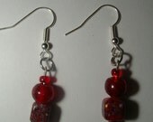red glass beads with silver accents dangle earrings