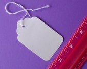 white scalloped top tags with string . 50 pieces