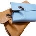 grommet leather clutch
