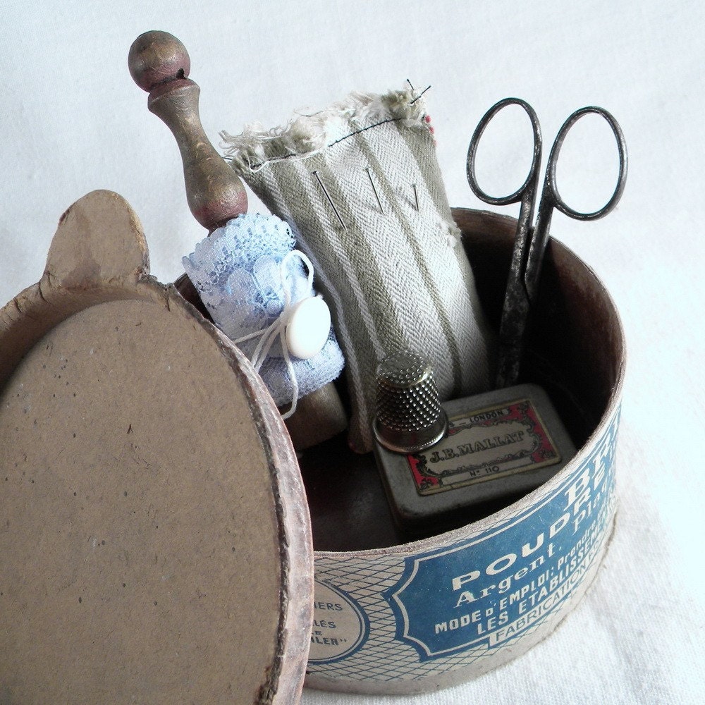 Vintage sewing kit with scissors, lace, lace bobbin, buttons, tin box, pincushion, thimble