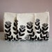 flora pleat pouch in black and white