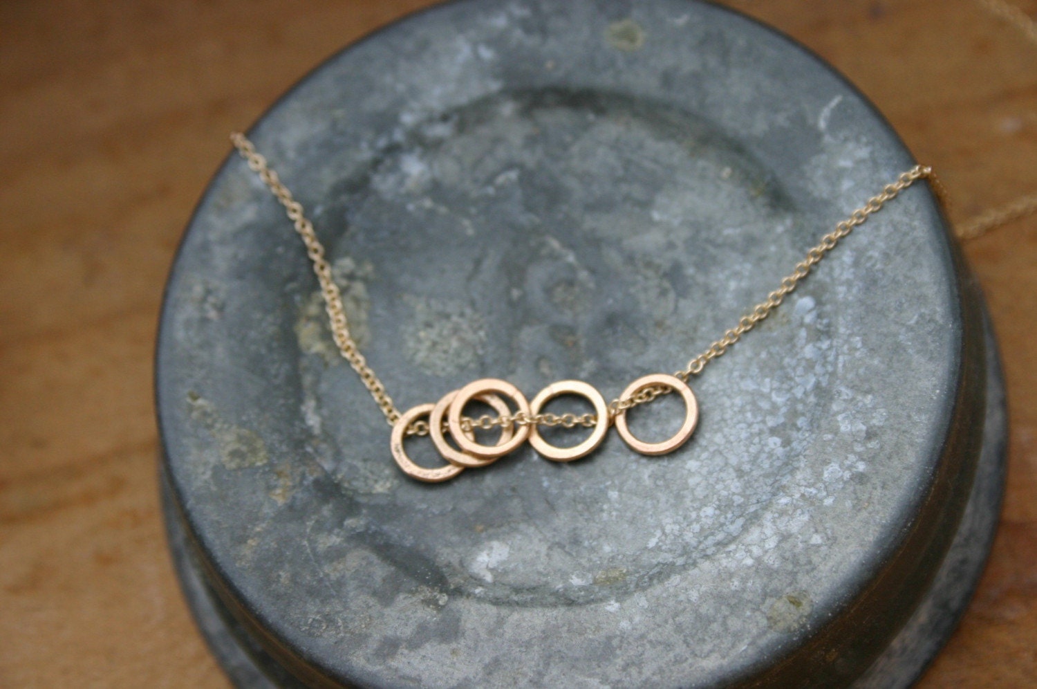 5 gold circle necklace.