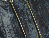 large gold stick earring.