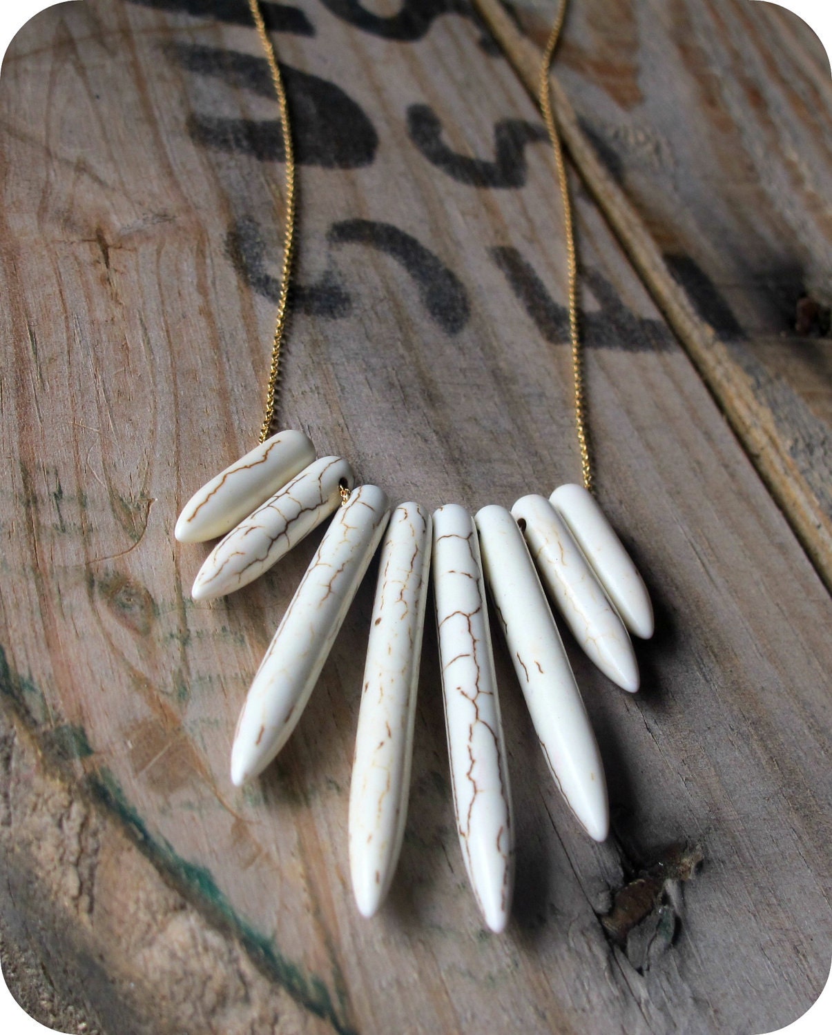 white stick beads on gold chain necklace.