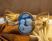 50 percent off until January 8th. Use the code Birthday. Blue Poured Agate Cameo of Mother and Son Bangle Bracelet