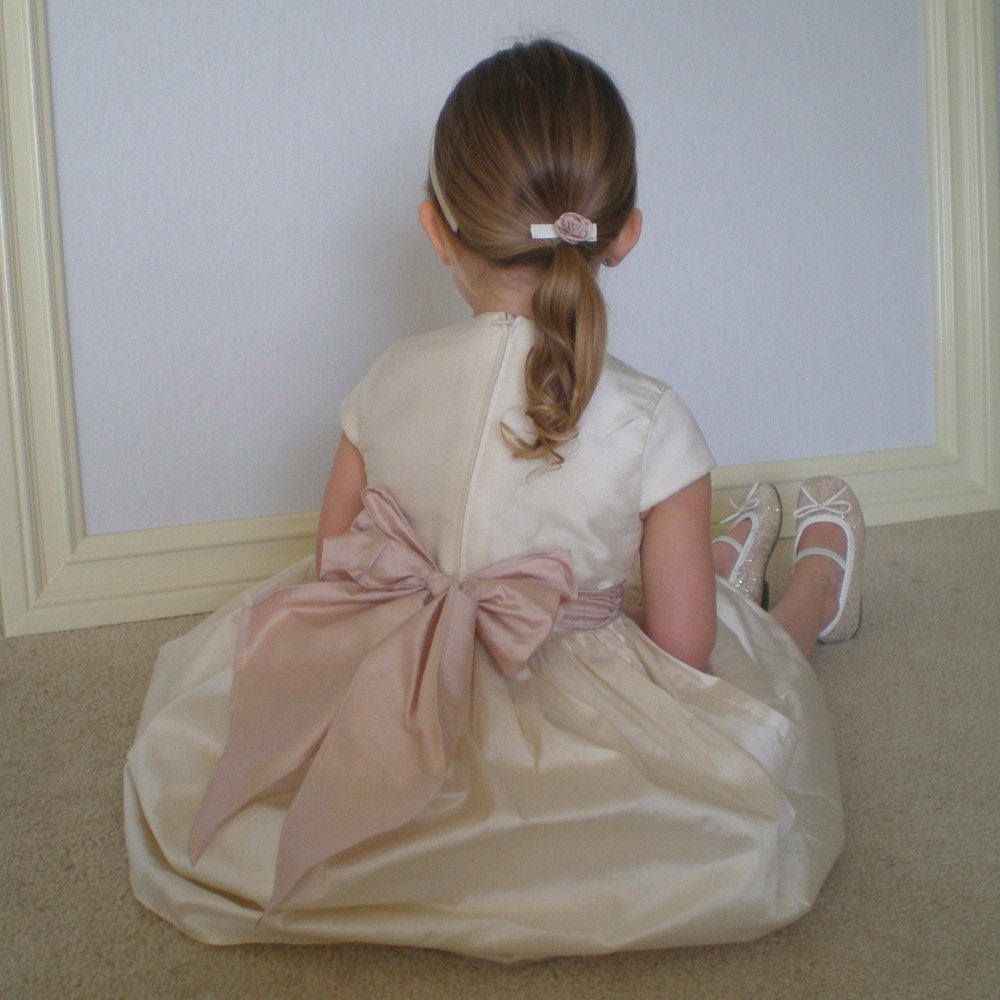the Isabella dress in cream dupioni silk with a blush sash