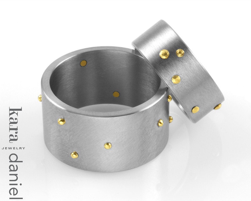 gold rivet in narrow stainless band . ring