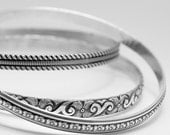 2  larger sterling silver detailed bangle bracelets