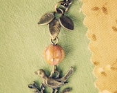 peach bird and leaf necklace