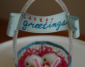 Fuzzy Chicks, one in bunny ears, in wire basket