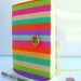 Stripes Journal Notebook designed with colorful fabric opens with a vintage brass colorful button and white ribbon