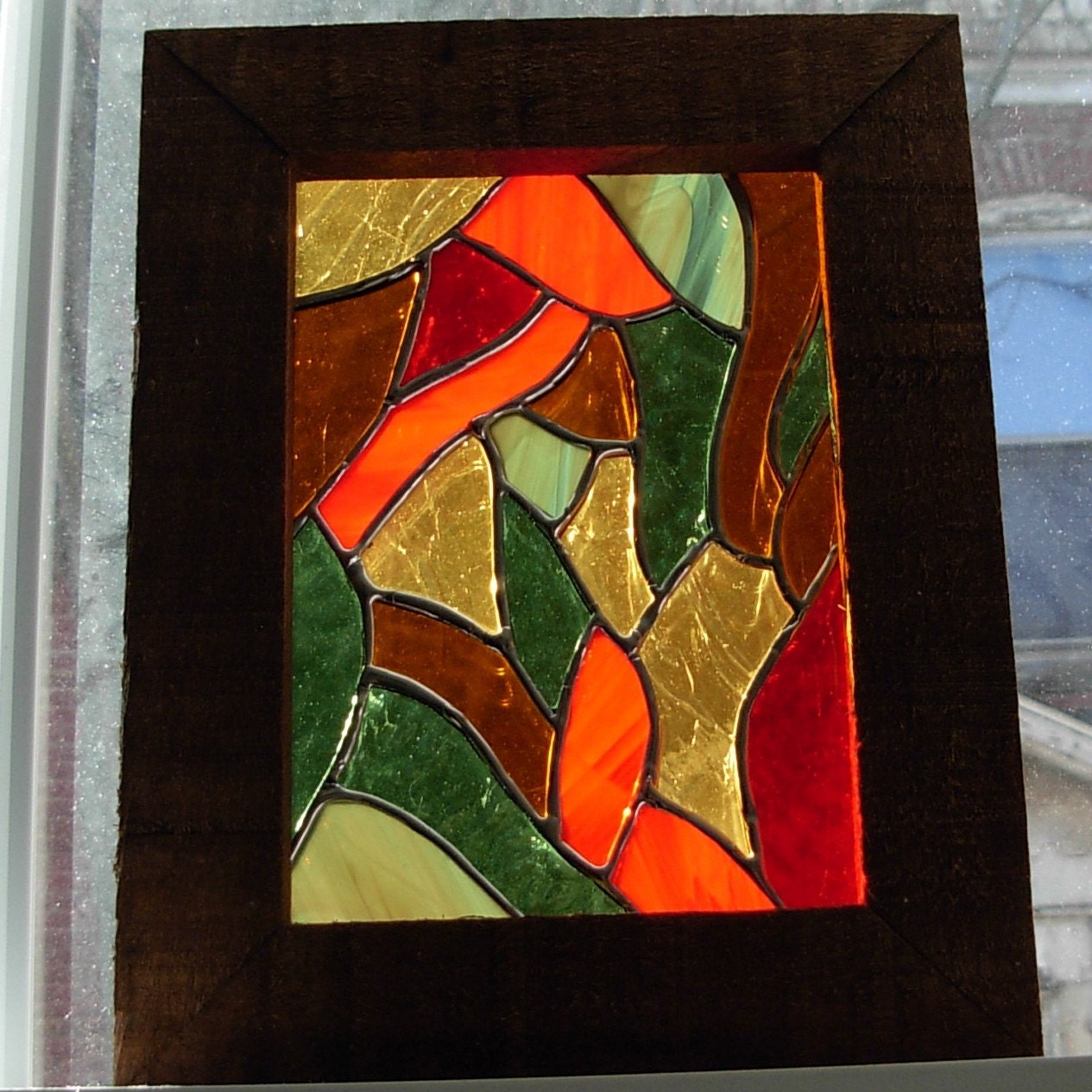 Swirling in from the outside a stained glass panel