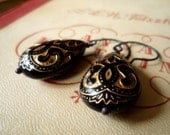Black teardrop earrings with golden pattern