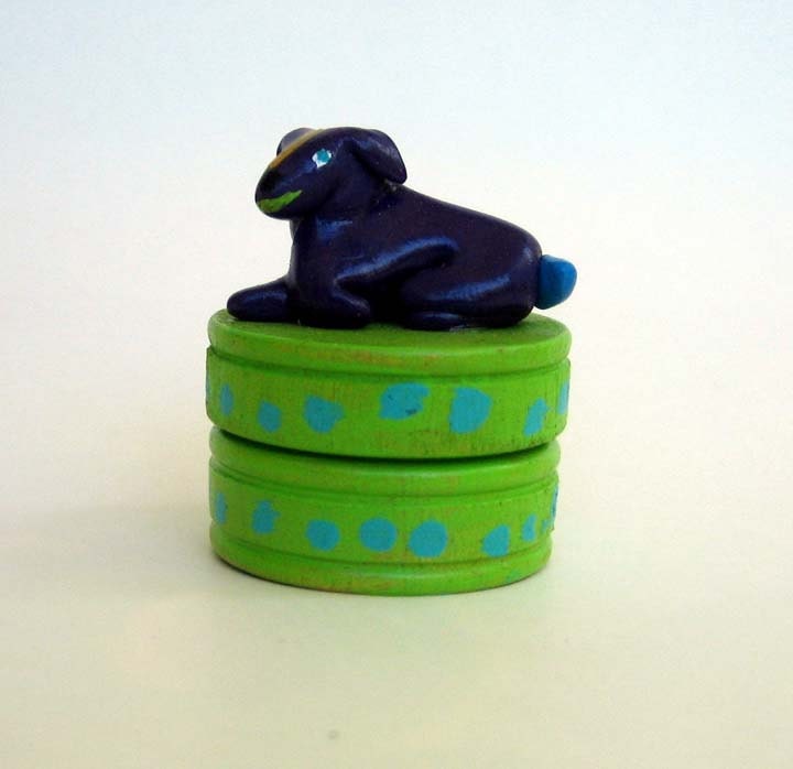 Colorful painted box with a purple dog on top