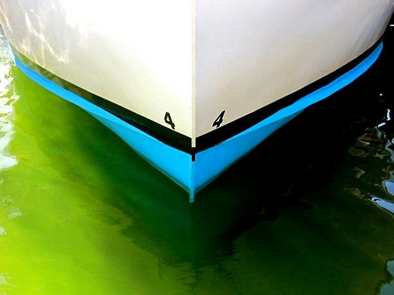 Hull Number Four: fine art photograph print of fishing boat in white, blue, and black with green ocean water