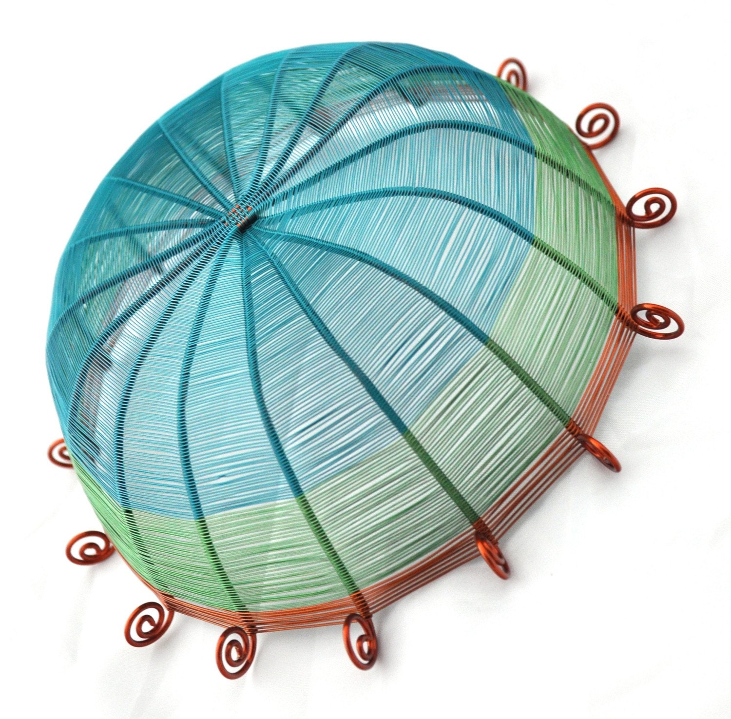 Sixteen sided copper wire basket in teal blue, green, and brown
