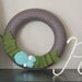 yarn wreath, greenery.