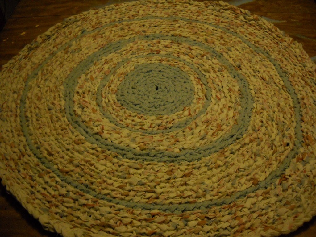 Crochet rug with flecked browns accented pale green fleece handmade