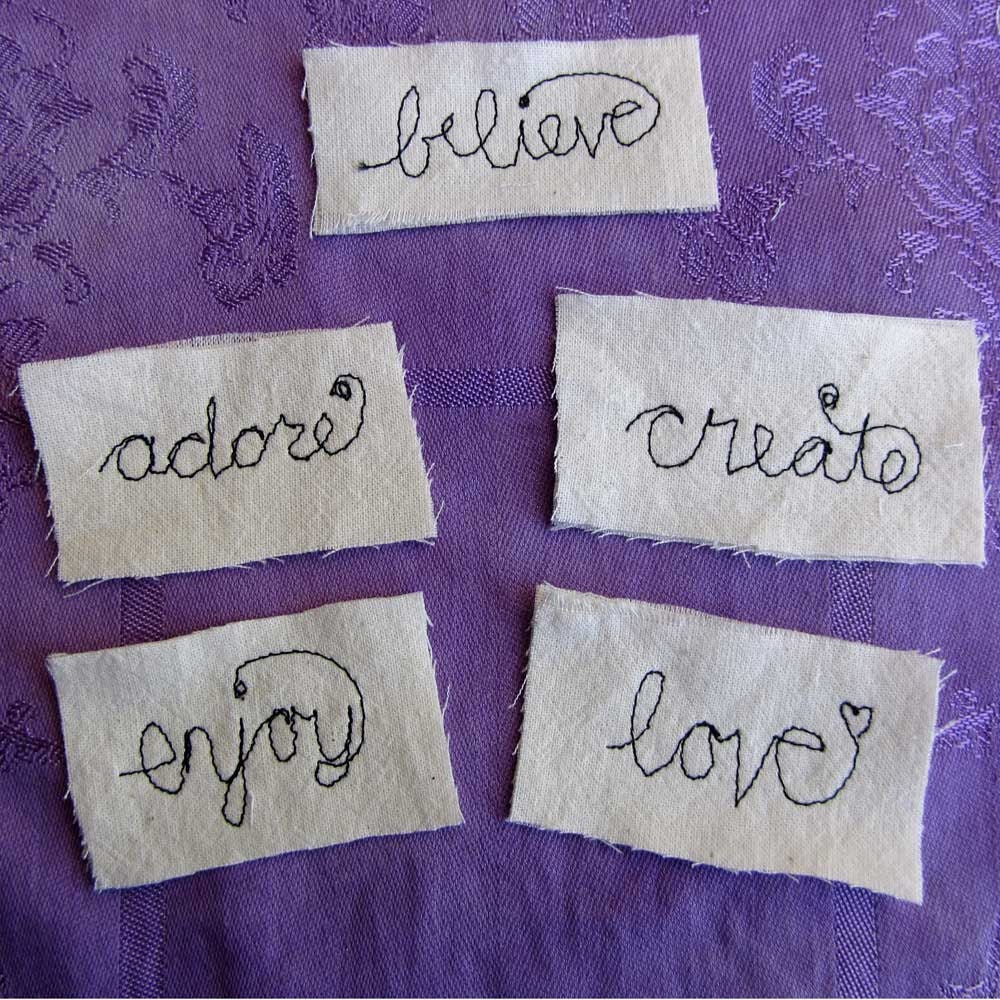 Free motion, machine stitched words on fabric