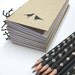 Notebook  with Two Birds and a Pencil