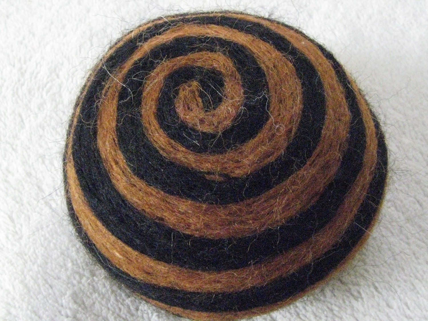 One multi-colored felted pin-cushion, Brown and Black