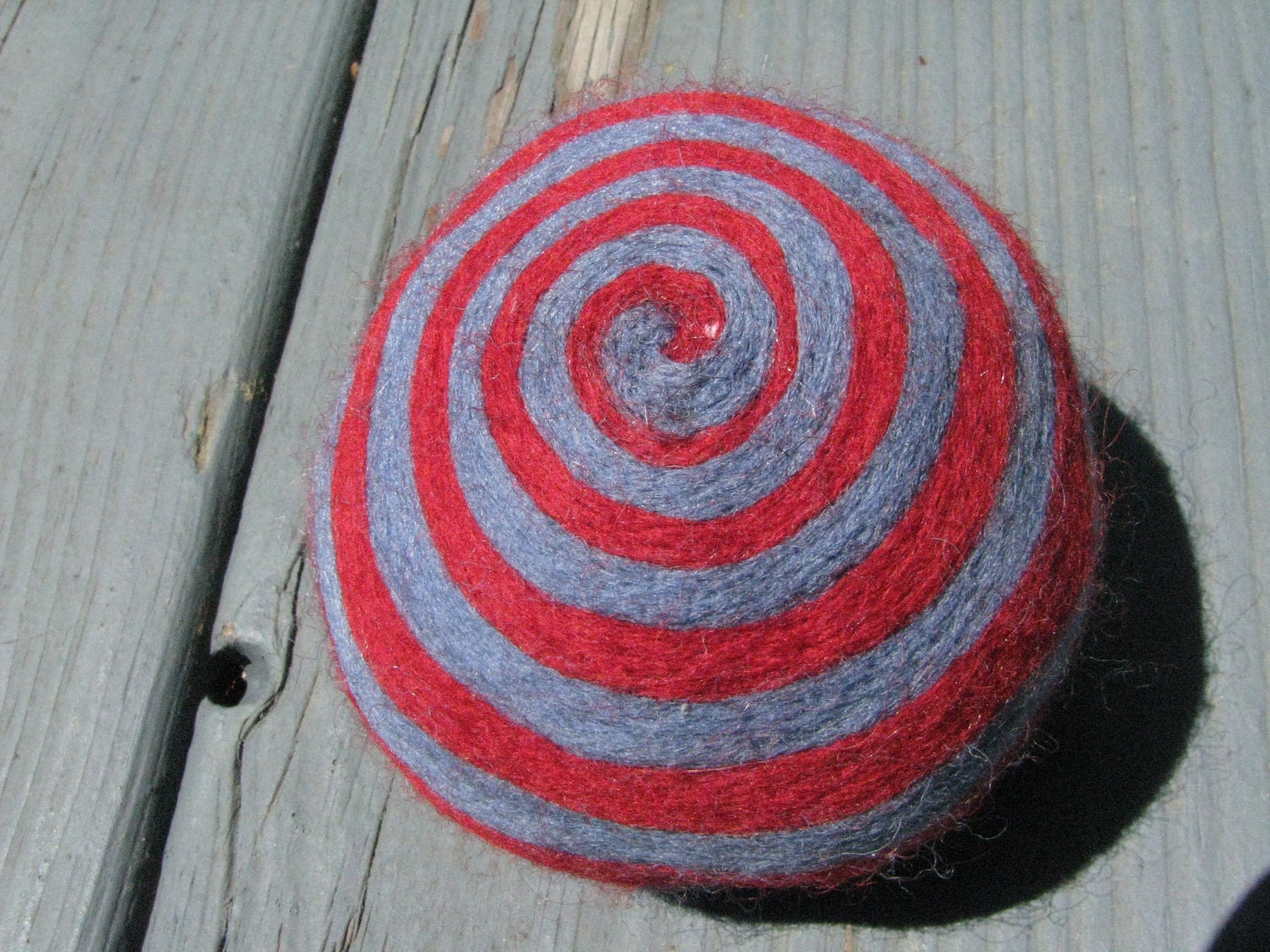 One multi-colored felted pin-cushion, Red and Blue