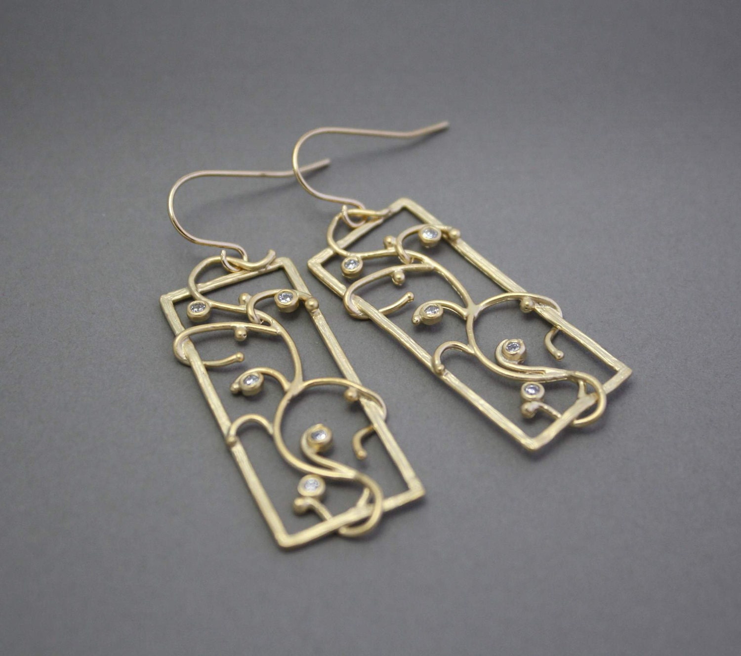 Ornate gold earrings with cubic zirconia