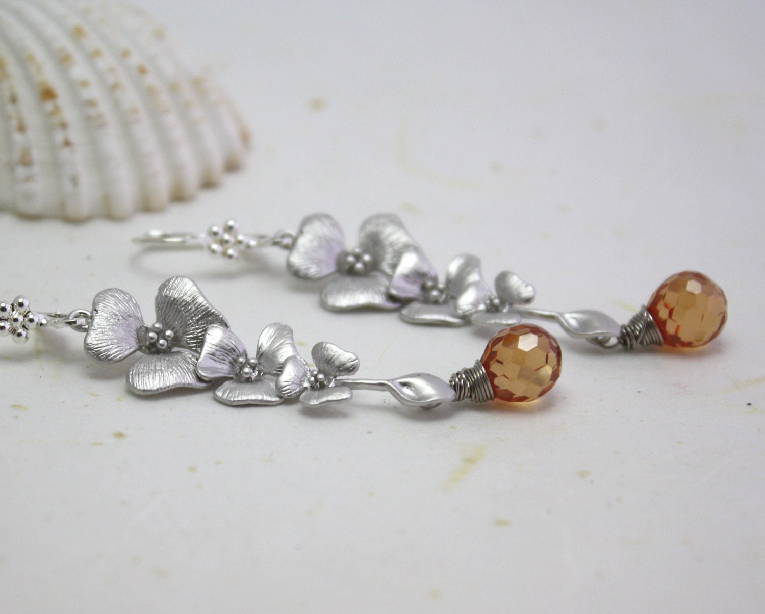 Long silver orchid earrings with peach cubic zirconia