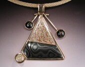 Mokume Gane Psilomelane Pendant in 18 karat Gold with Star Diopsides and Rutilated Quartz MOUNT SAINT HELENS
