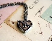 loves dinosaurs. locket necklace. silver ox