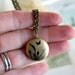 butterfly. locket necklace. brass ox