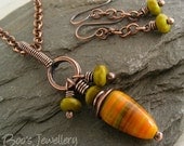 Antiqued copper necklace and earring set with a wire wrapped feature bail loop with yellow, orange and olive green glass beads