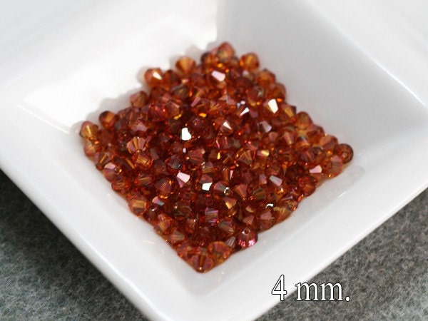 100 pcs. Swarovski Crystal Bicone Copper 4 mm.