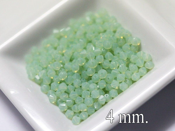 100 pcs. Swarovski Crystal Bicone Chrysolite Opal 4 mm.