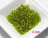 100 pcs. Swarovski Crystal Bicone Light Olivine 4 mm.