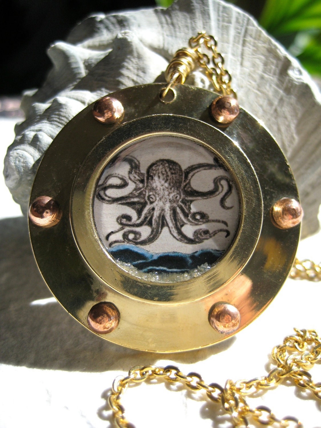 Off the Starboard Bow. Vintage octopus illustration in brass porthole necklace
