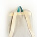 light grey denim backpack with magenta pouch