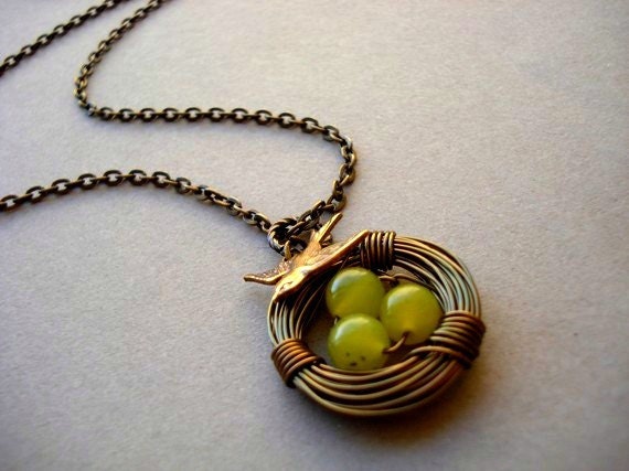 Bird Nest Necklace in brass with olive-green eggs