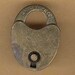 a little patinaed lock charm brass old school