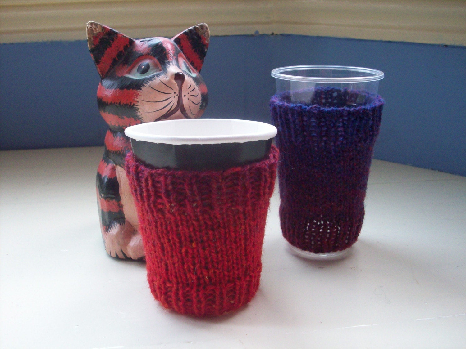 Fun coffee cup cozies pair red purple rainbow sleeves