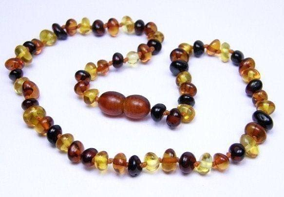 Rounded beads Multicolored amber teething necklace for your baby.