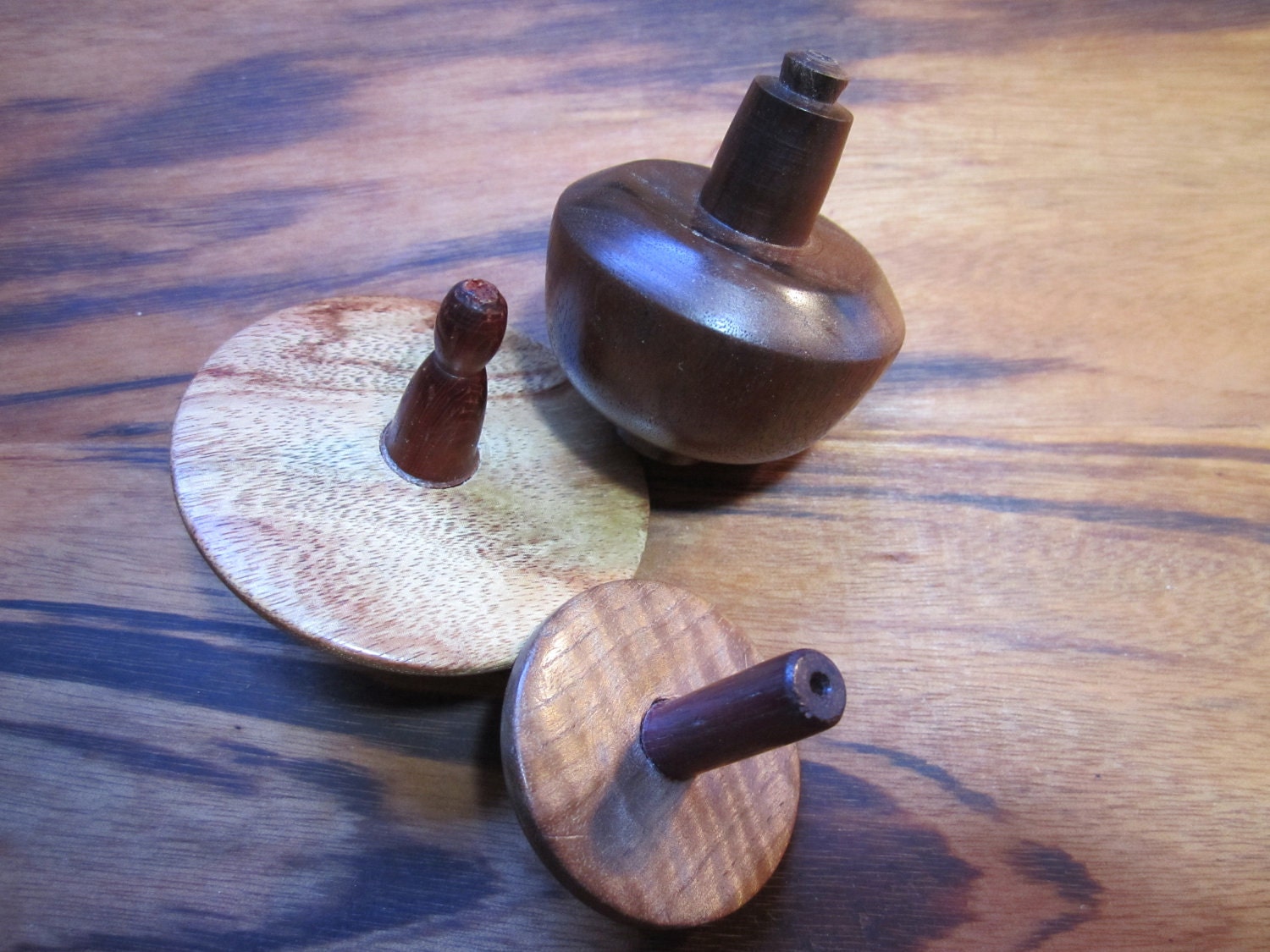 Three handmade wooden toy spinning tops C