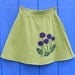 Purple Flowers on a Lime Green Skirt